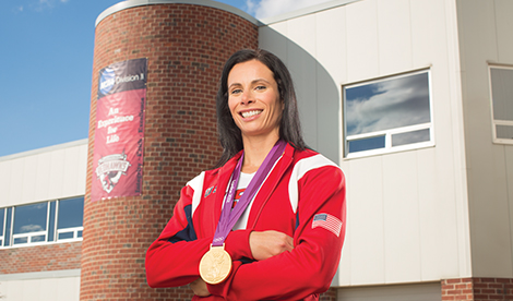 Jenn Suhr smiles with medal around neck